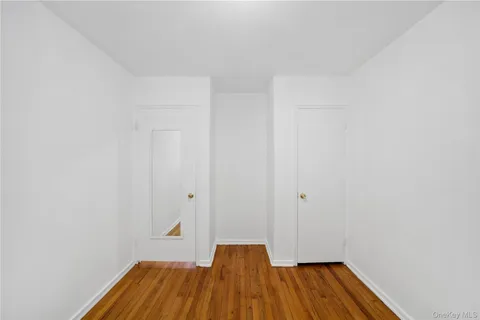 a view of a room with wooden floor and white wall