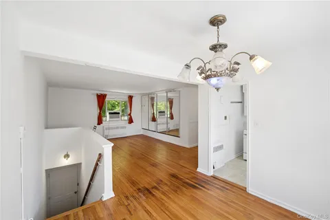 a view of a bedroom with wooden floor