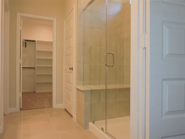 a bathroom with a glass shower door