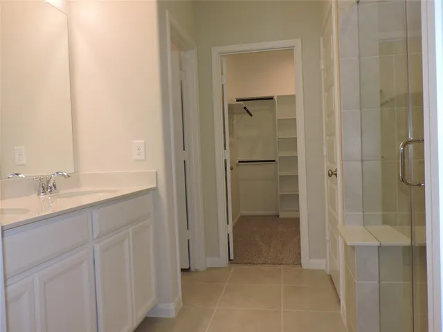 a spacious bathroom with a shower and a sink