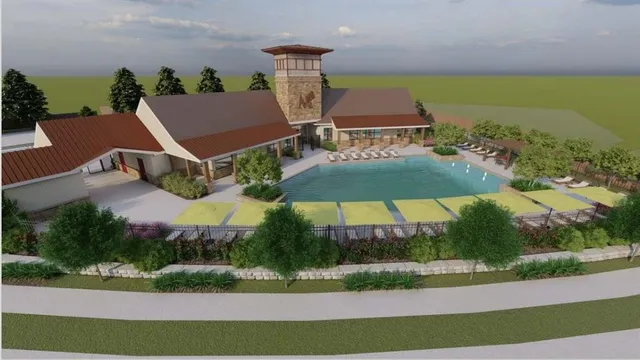 an aerial view of a house with a yard and lake view