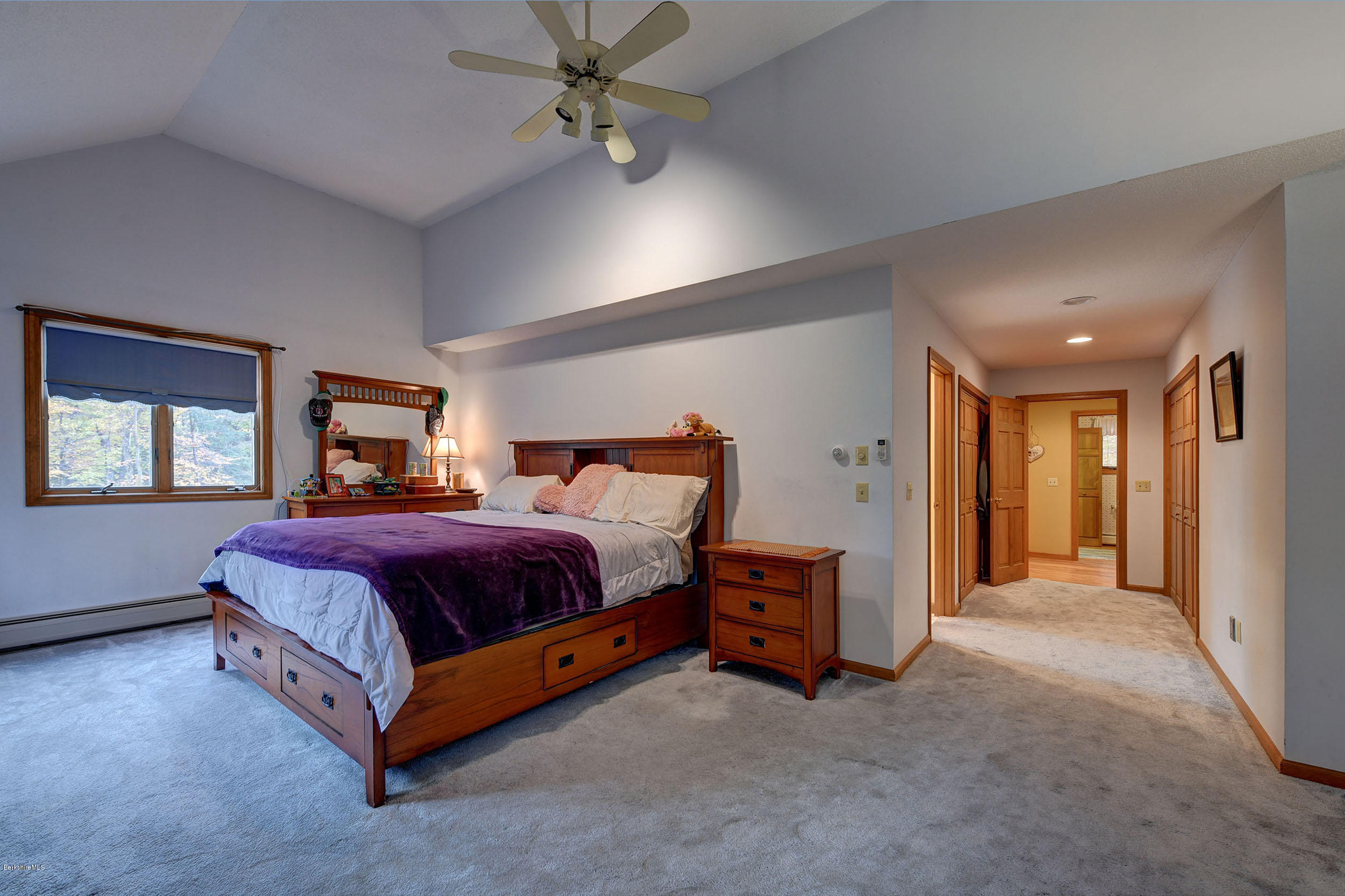 99 Jacobs Hollow Road Becket, MA 01223 - Photo 15 of 39 a spacious bedroom with a bed and a chandelier