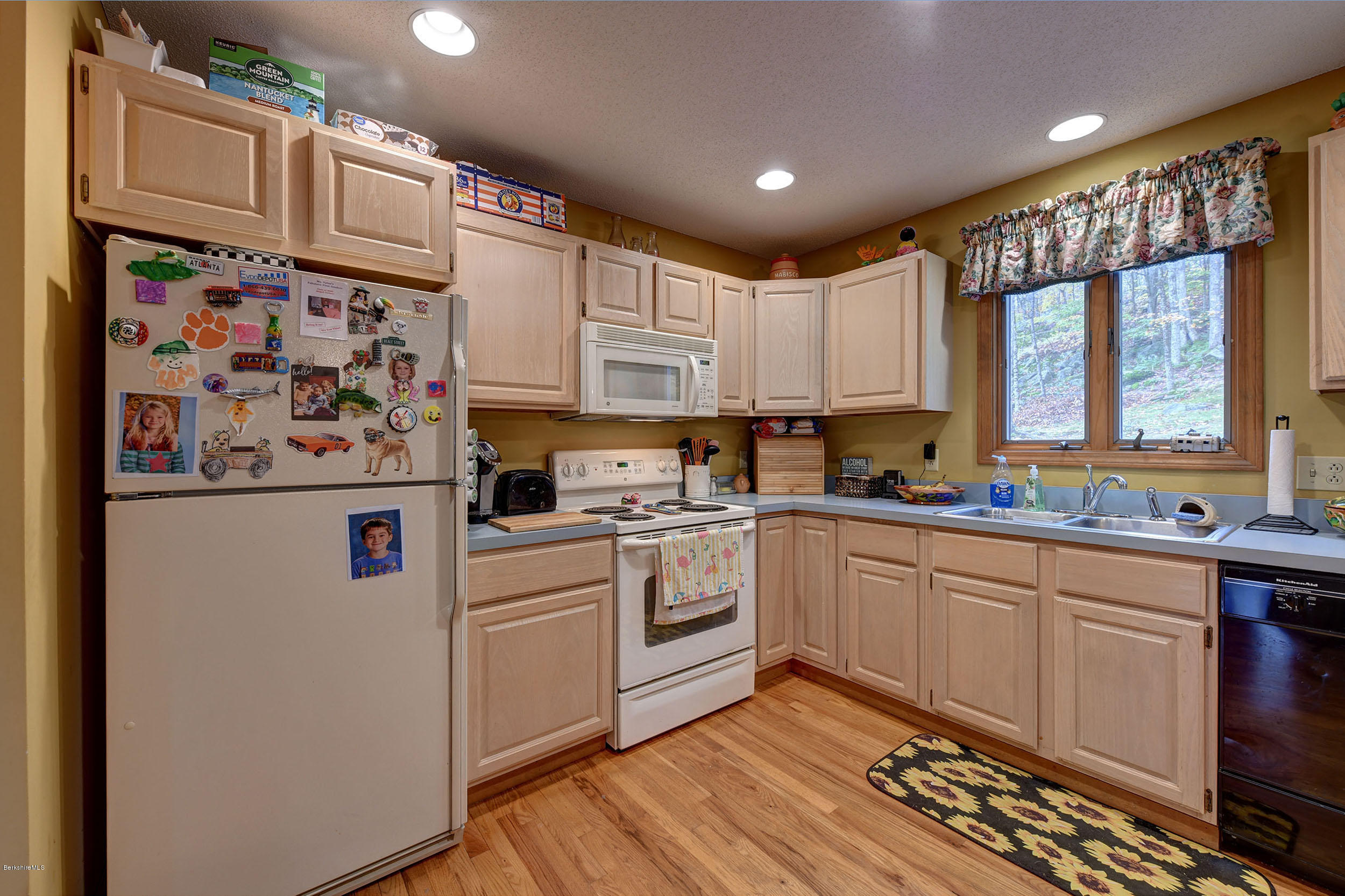 99 Jacobs Hollow Road Becket, MA 01223 - Photo 20 of 39 a kitchen with stainless steel appliances white cabinets and a refrigerator