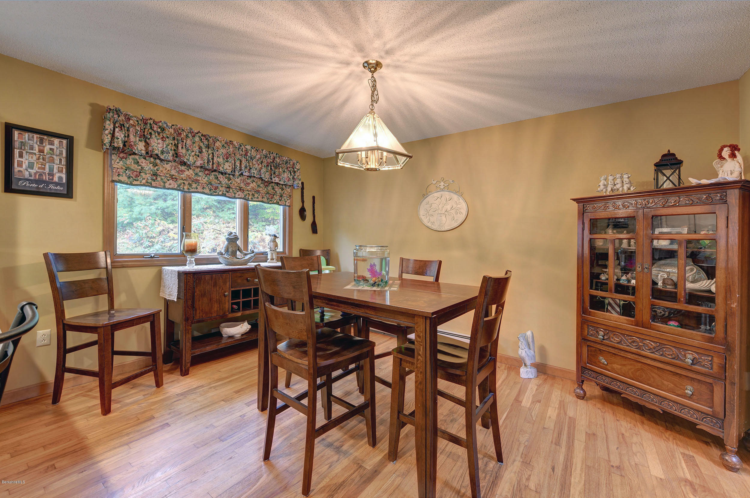 99 Jacobs Hollow Road Becket, MA 01223 - Photo 22 of 39 a view of a dining room with furniture window and wooden floor