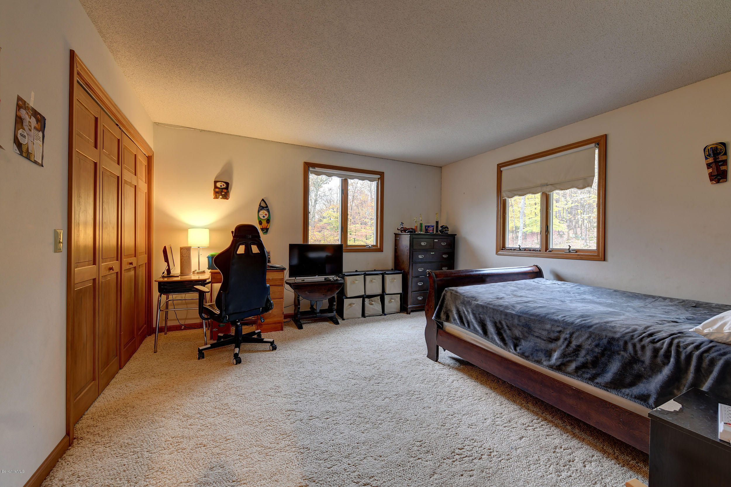 99 Jacobs Hollow Road Becket, MA 01223 - Photo 32 of 39 a bed room with a bed and a chair