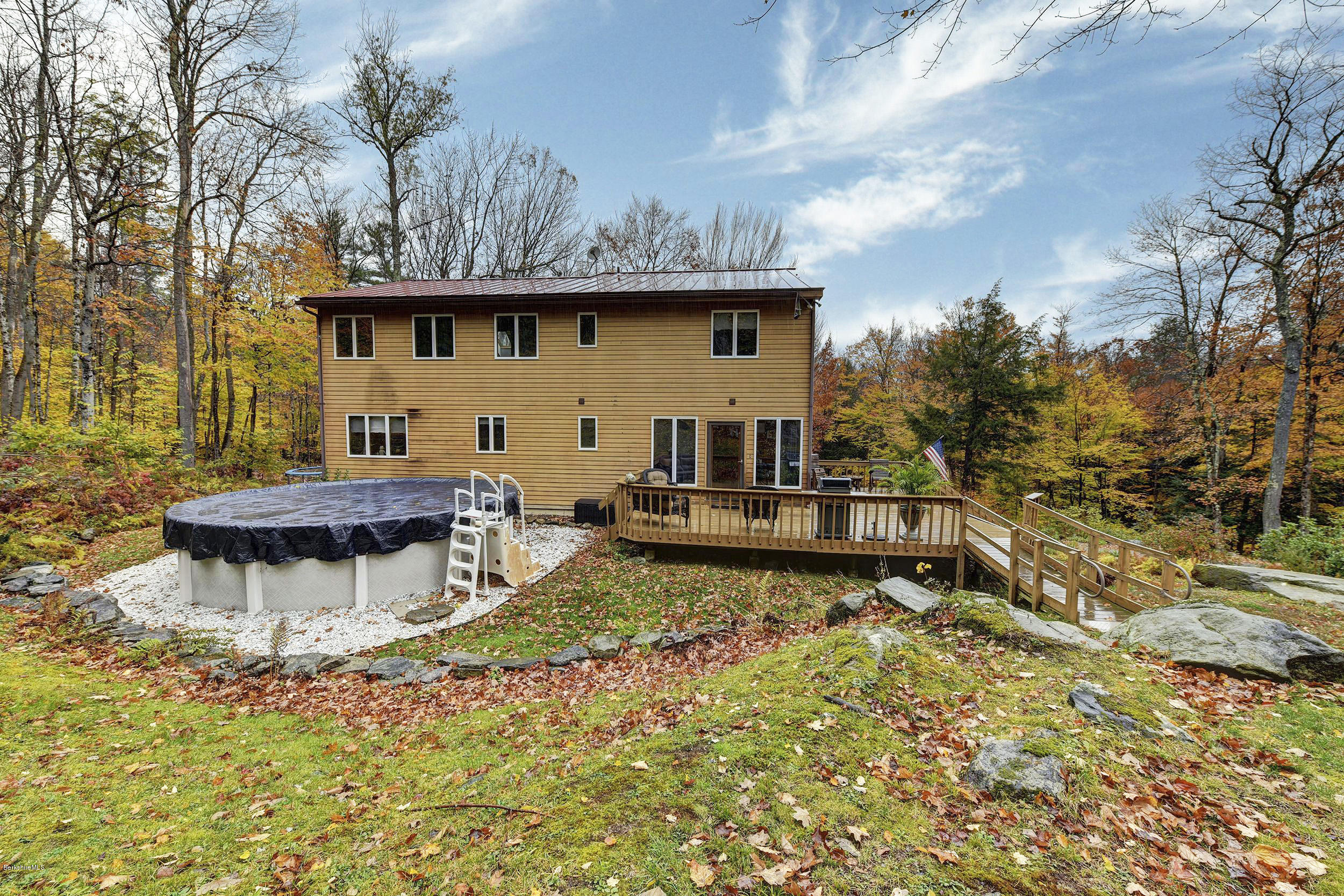 99 Jacobs Hollow Road Becket, MA 01223 - Photo 7 of 39 a view of a backyard with sitting area