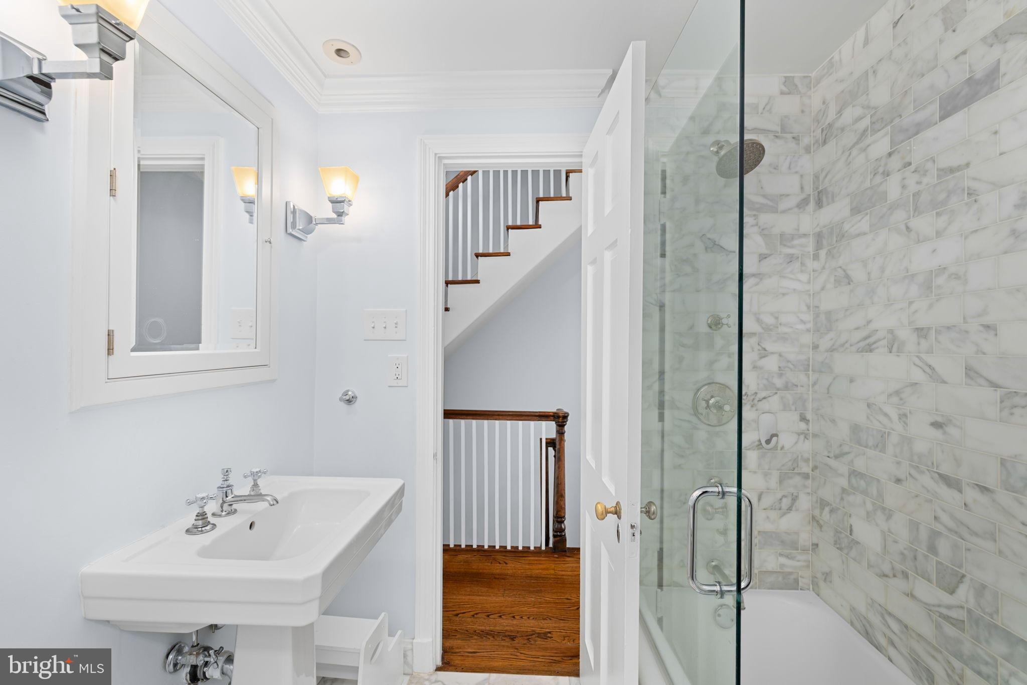 3127 O Street Northwest Washington, DC 20007 - Photo 7 of 13 a bathroom with a sink a mirror and shower
