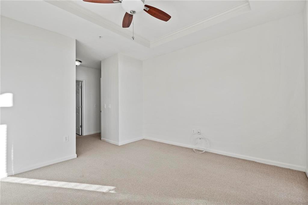 3334 Peachtree Road Northeast, Unit 1207 Atlanta, GA 30326 - Photo 16 of 31 an empty room with a ceiling fan and window