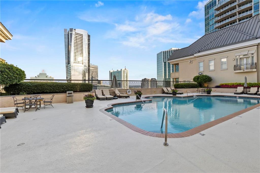 3334 Peachtree Road Northeast, Unit 1207 Atlanta, GA 30326 - Photo 20 of 31 a view of a swimming pool with outdoor seating