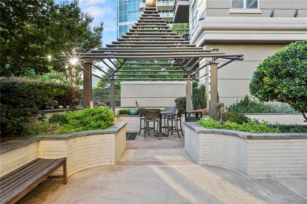 3334 Peachtree Road Northeast, Unit 1207 Atlanta, GA 30326 - Photo 22 of 31 a view of a patio with table and chairs and potted plants