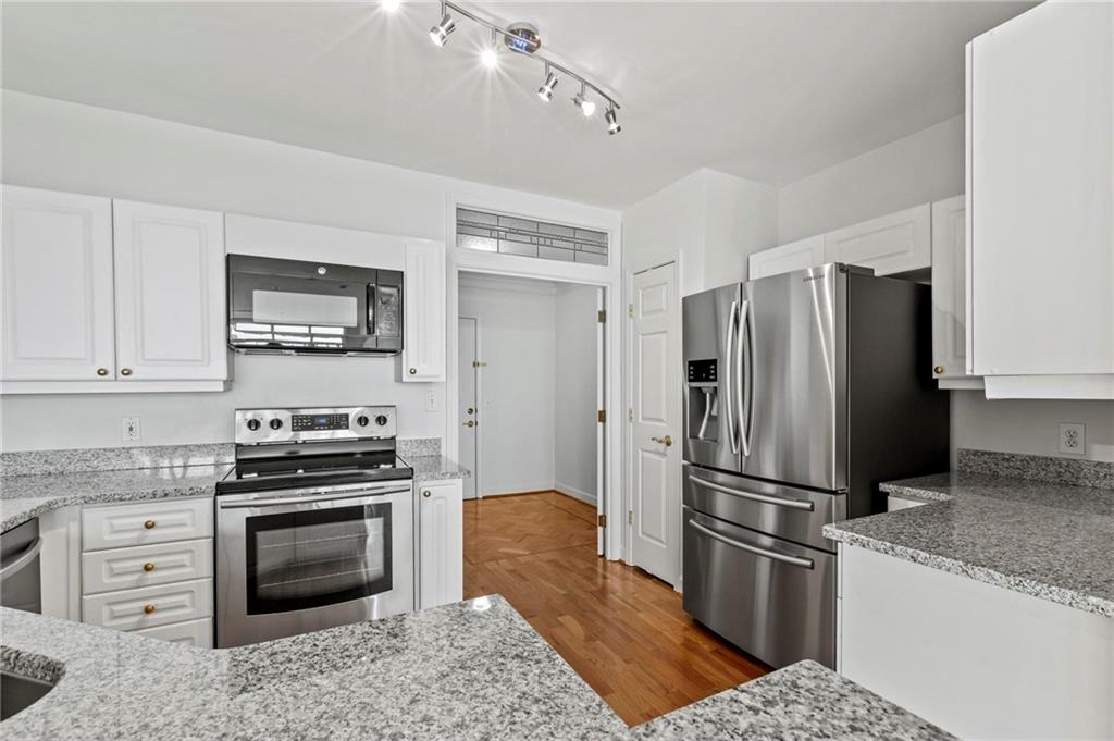 3334 Peachtree Road Northeast, Unit 1207 Atlanta, GA 30326 - Photo 6 of 31 a kitchen with granite countertop a refrigerator stove and sink