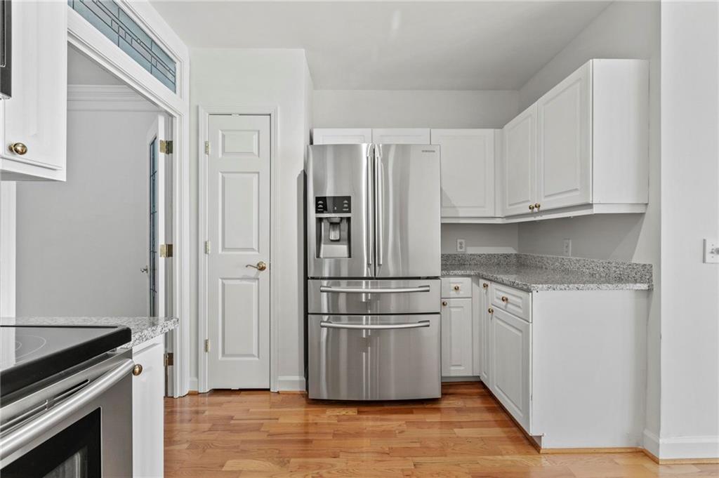 3334 Peachtree Road Northeast, Unit 1207 Atlanta, GA 30326 - Photo 9 of 31 a kitchen with stainless steel appliances granite countertop a refrigerator and a stove top oven