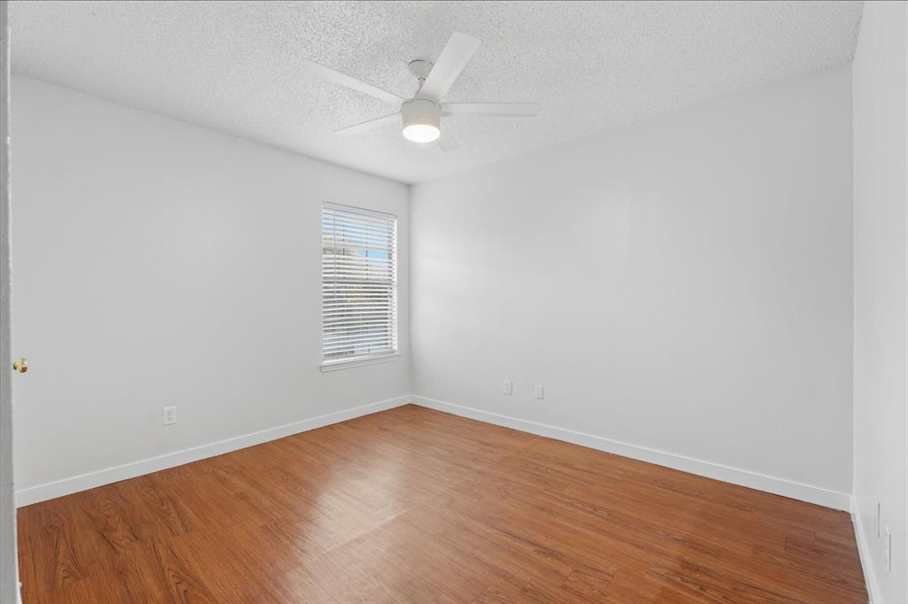 3721 Smartt Street Rowlett, TX 75088 - Photo 19 of 27 a view of an empty room with wooden floor and a window