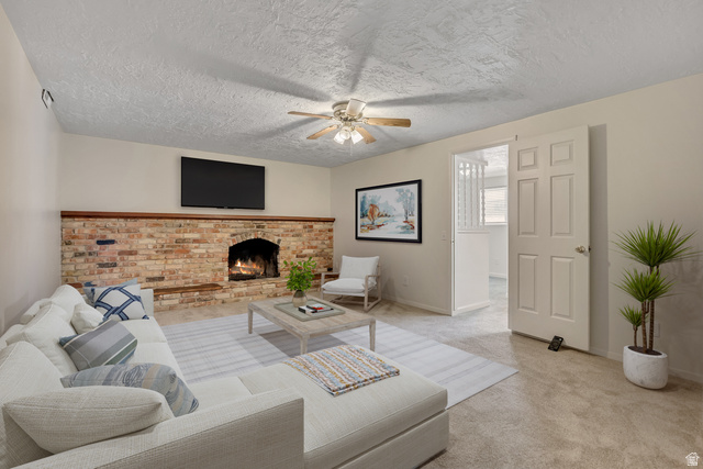 3166 Linden Street Bountiful, UT 84010 - Photo 4 of 25 Family room featuring carpet, ceiling fan, a brick fireplace, and a textured ceiling (virtually staged)