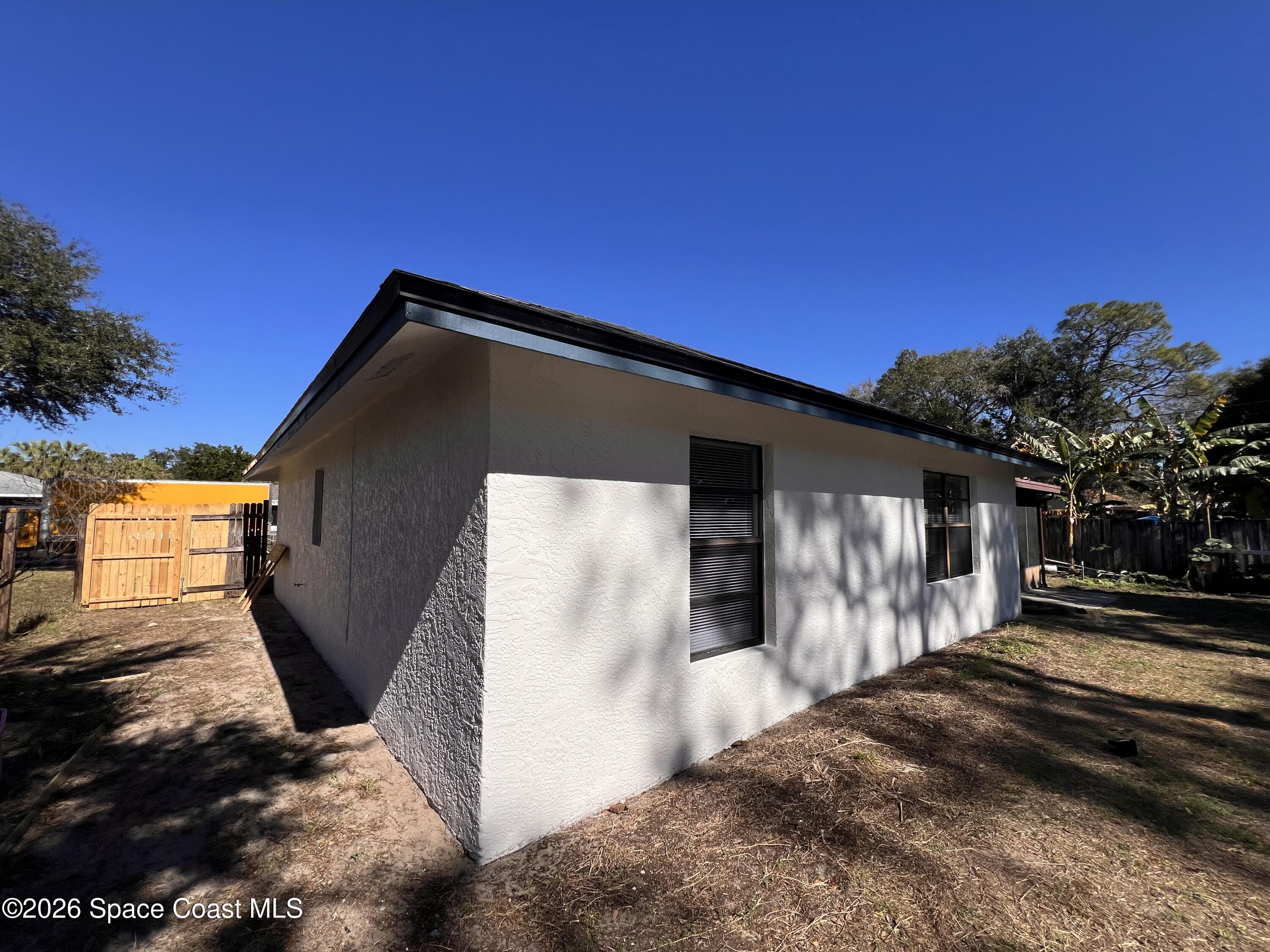 1456 Reed Street Northwest Palm Bay, FL 32907 - Photo 19 of 19 a view of a house with a yard
