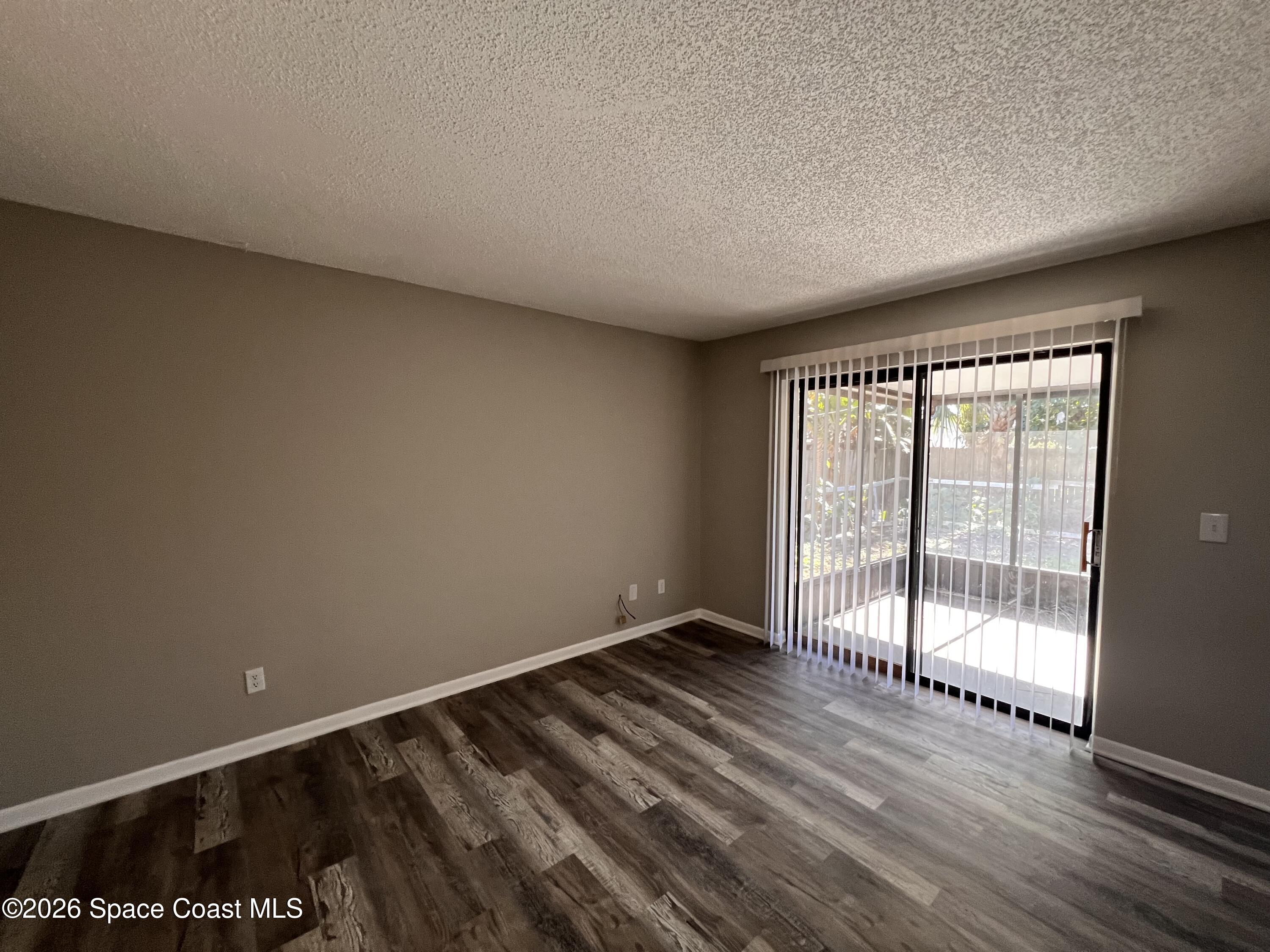 1456 Reed Street Northwest Palm Bay, FL 32907 - Photo 3 of 19 wooden floor in an empty room with a window