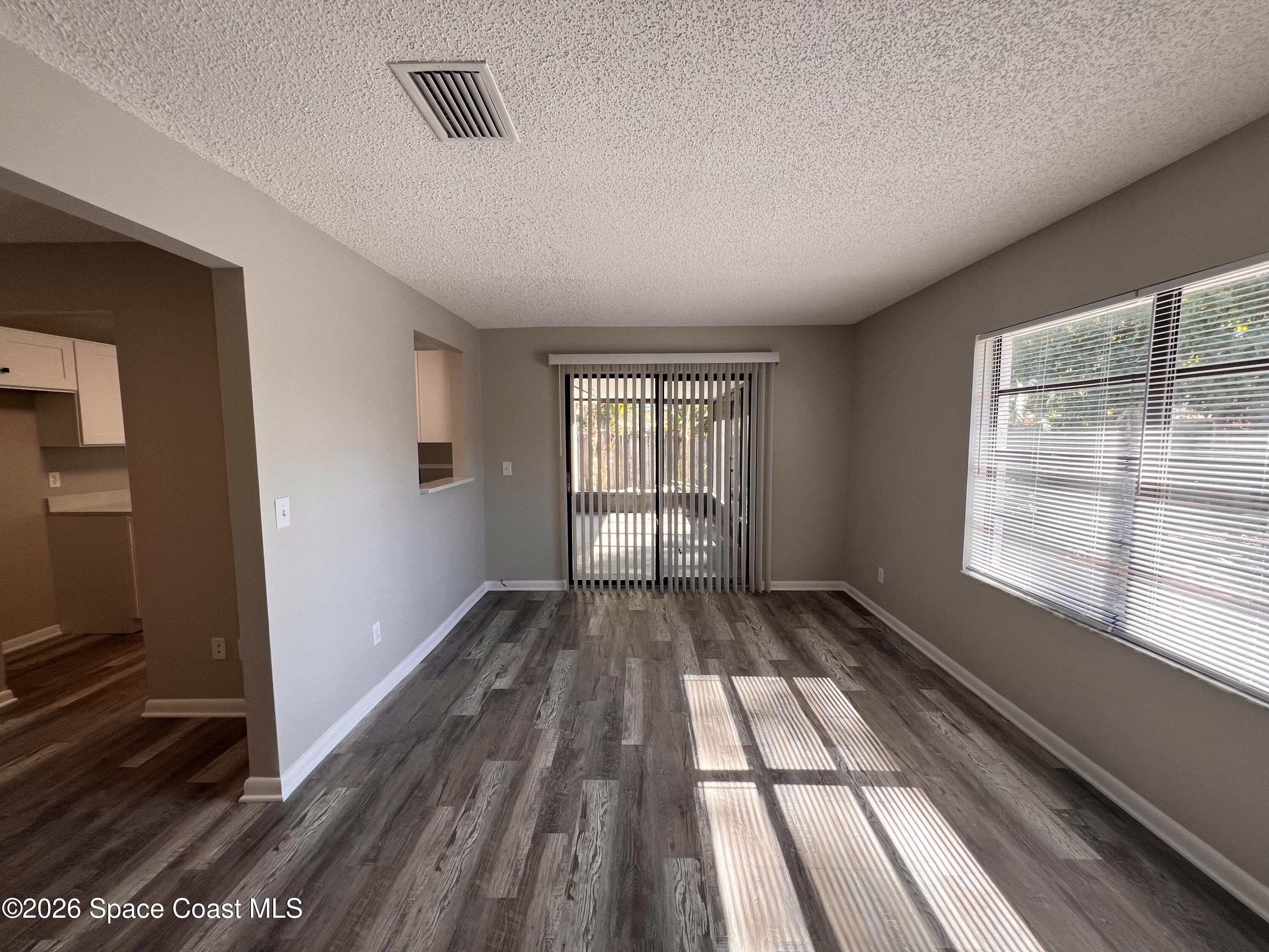 1456 Reed Street Northwest Palm Bay, FL 32907 - Photo 4 of 19 a view of empty room with wooden floor and fan
