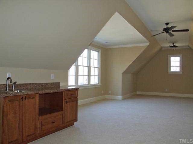 5136 Terra Cotta Drive Raleigh, NC 27613 - Photo 11 of 12 an empty room with a chandeliers fan and windows