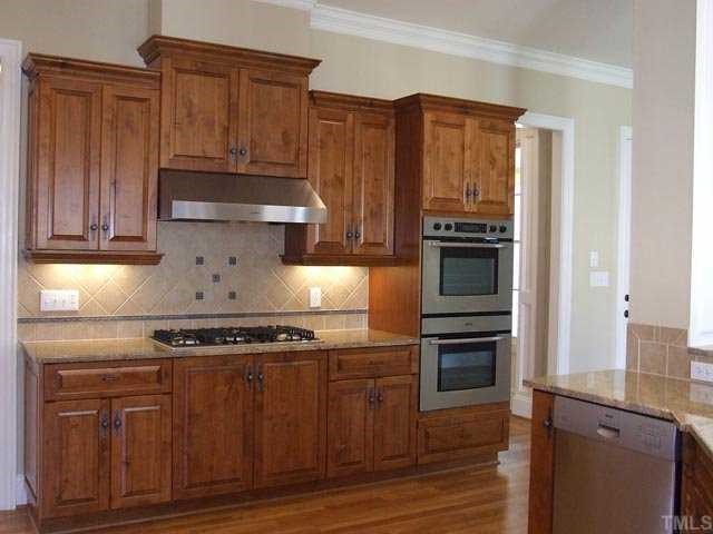 5136 Terra Cotta Drive Raleigh, NC 27613 - Photo 5 of 12 a kitchen with granite countertop wooden cabinets and stainless steel appliances