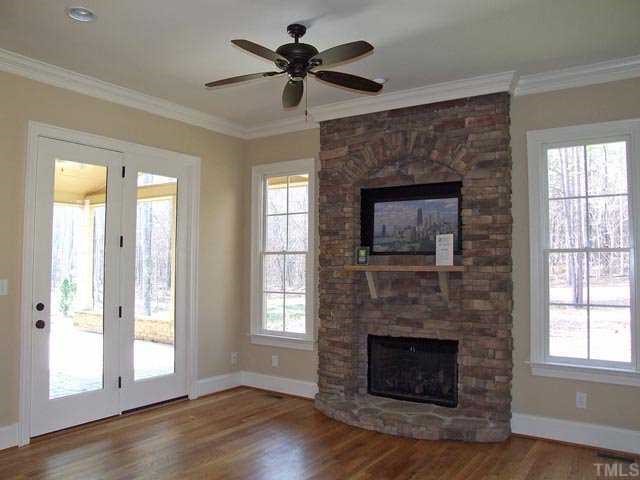 5136 Terra Cotta Drive Raleigh, NC 27613 - Photo 6 of 12 a living room with a fireplace and windows
