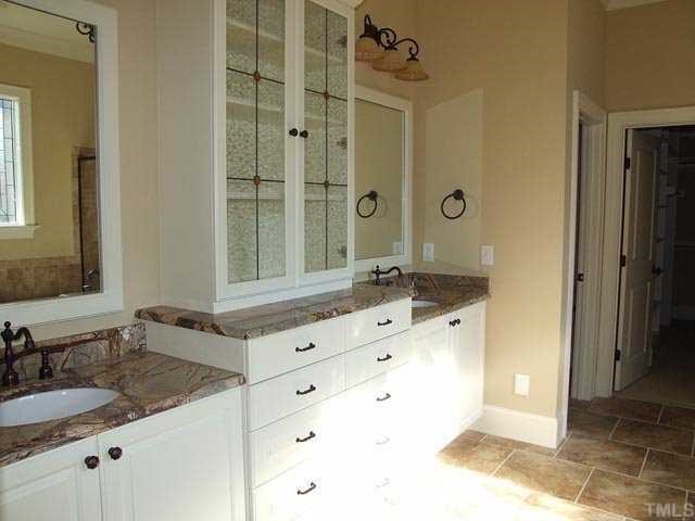5136 Terra Cotta Drive Raleigh, NC 27613 - Photo 9 of 12 a bathroom with a sink and a mirror