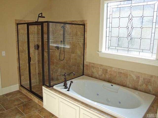5136 Terra Cotta Drive Raleigh, NC 27613 - Photo 10 of 12 a bathroom with a bathtub and shower