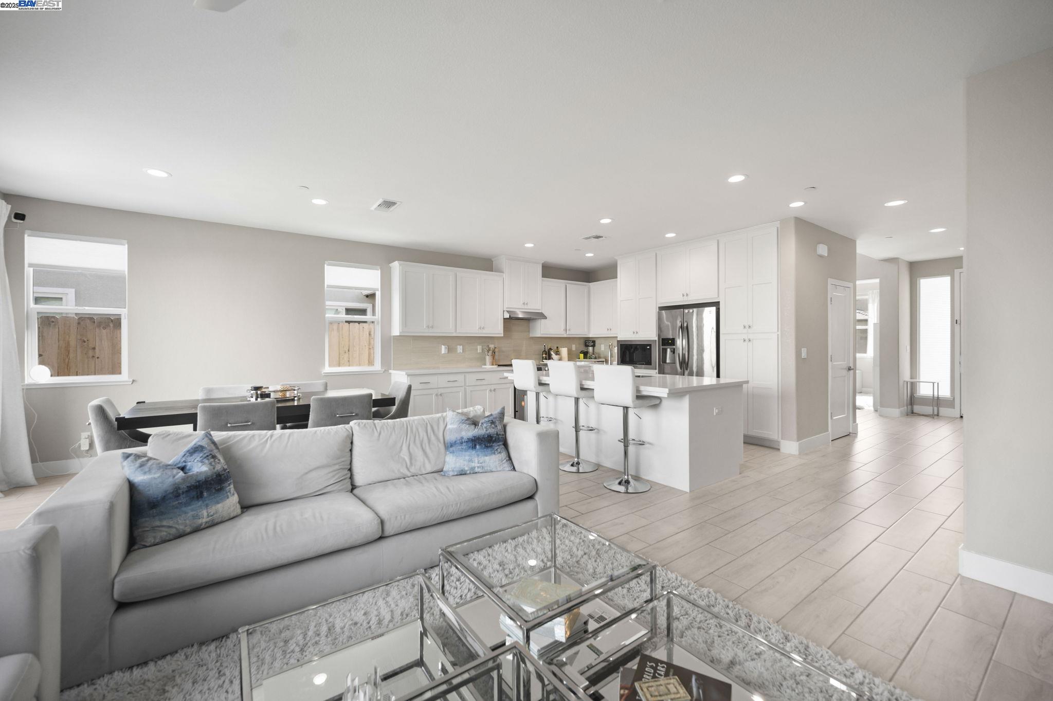 1605 Radiance Lane Modesto, CA 95356 - Photo 15 of 35 a living room with furniture and kitchen view with wooden floor