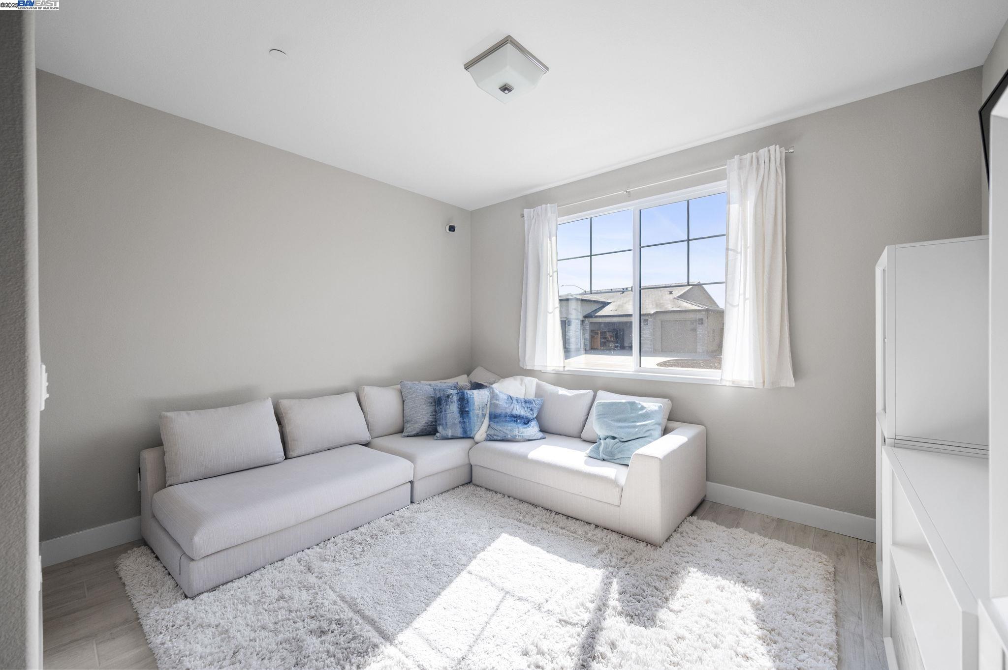1605 Radiance Lane Modesto, CA 95356 - Photo 23 of 35 a living room with furniture and a window