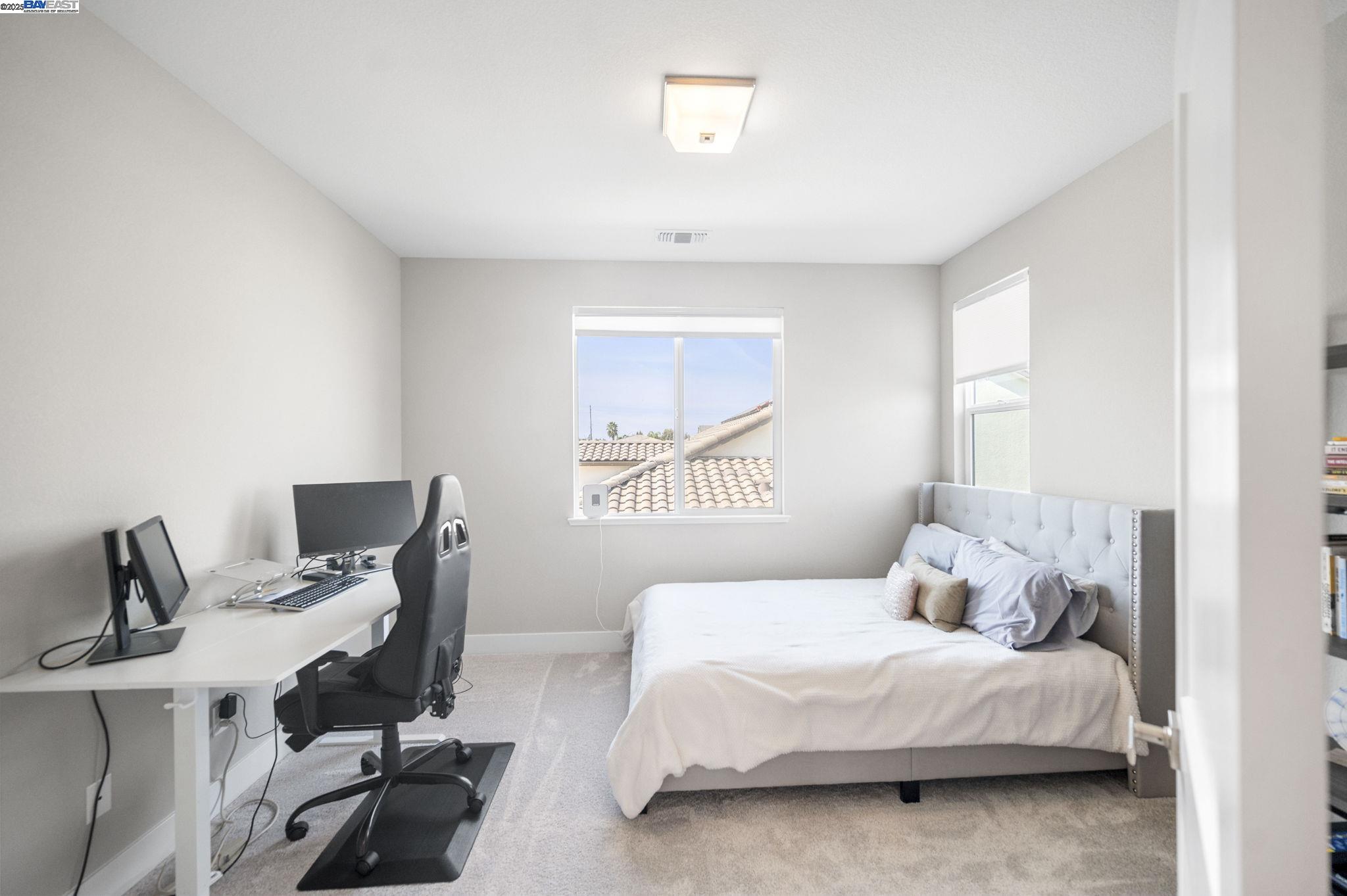 1605 Radiance Lane Modesto, CA 95356 - Photo 26 of 35 a bedroom with a bed and wooden floor