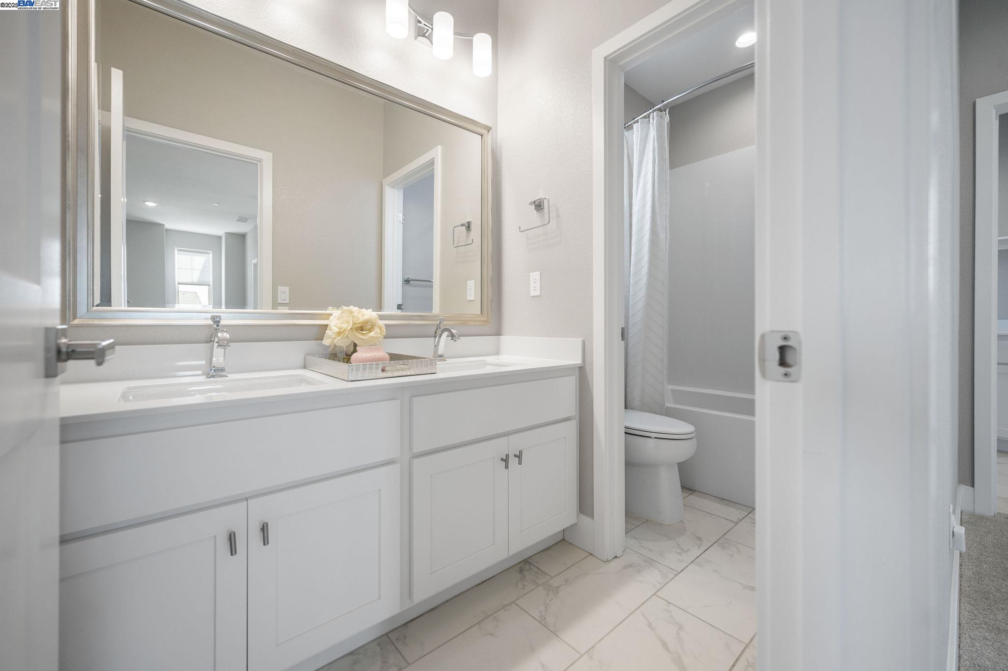1605 Radiance Lane Modesto, CA 95356 - Photo 27 of 35 a bathroom with a sink a toilet and shower