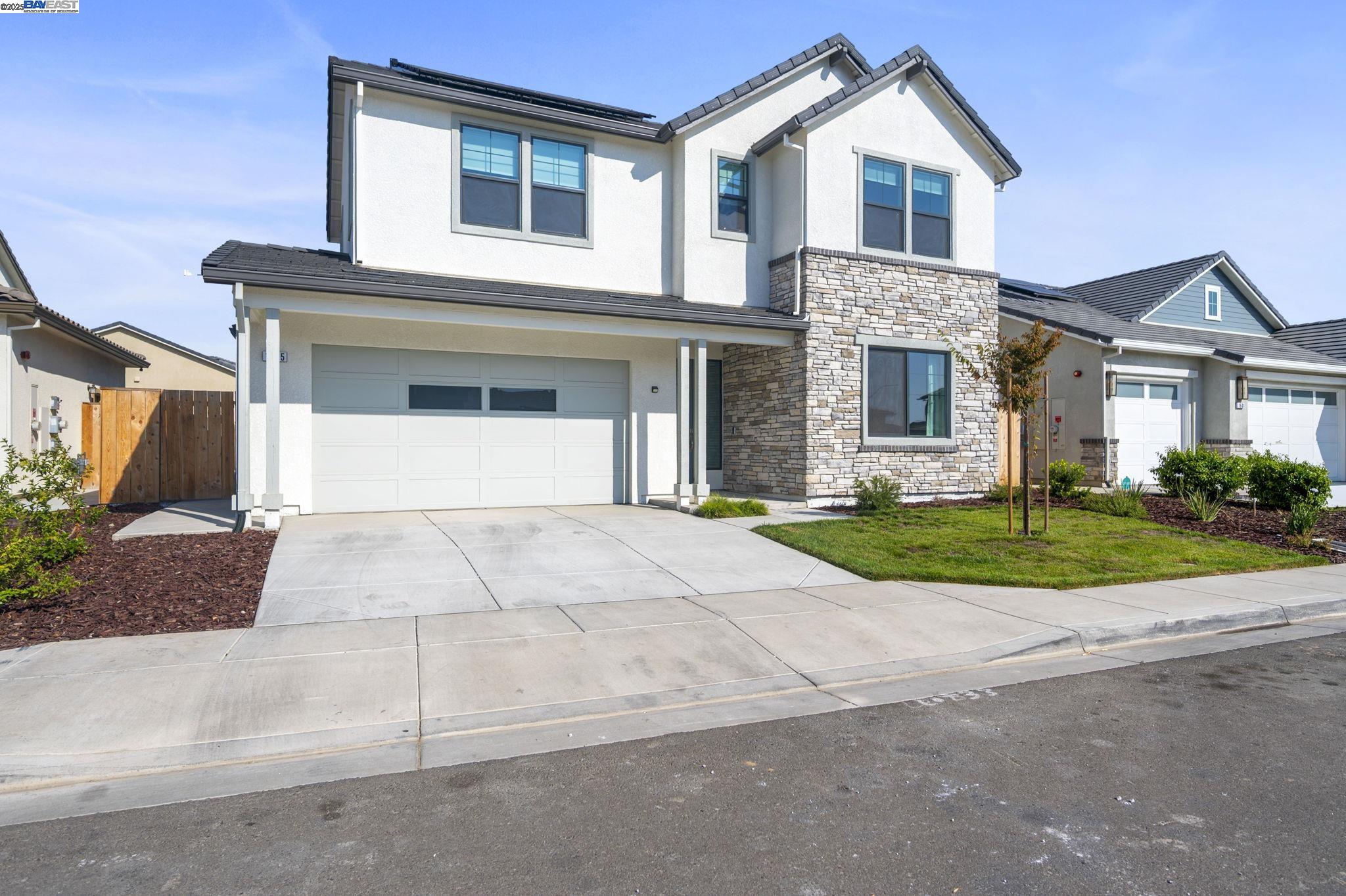 1605 Radiance Lane Modesto, CA 95356 - Photo 32 of 35 a front view of a house with a yard and garage