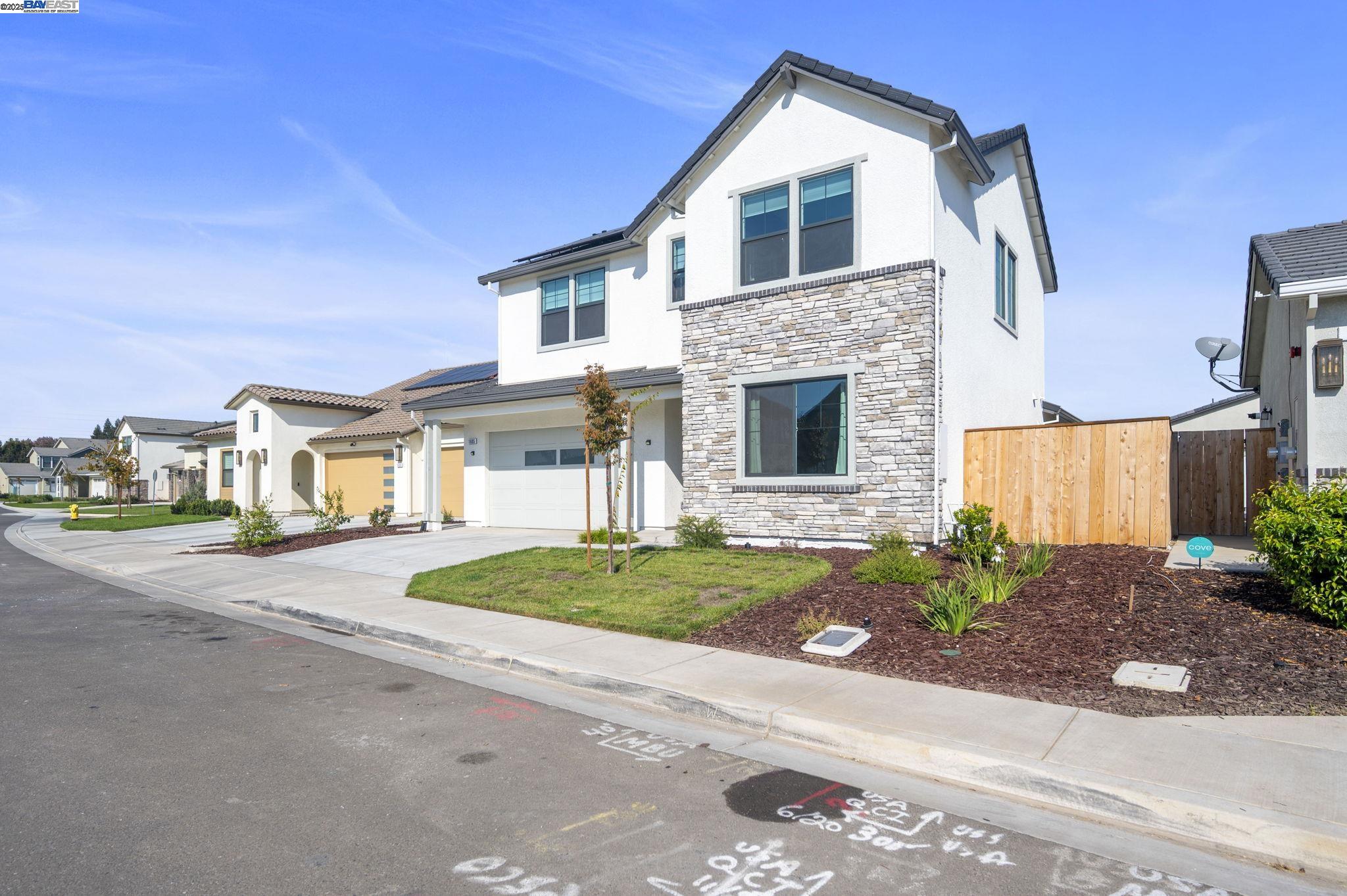 1605 Radiance Lane Modesto, CA 95356 - Photo 33 of 35 a front view of a house with a yard and a garage
