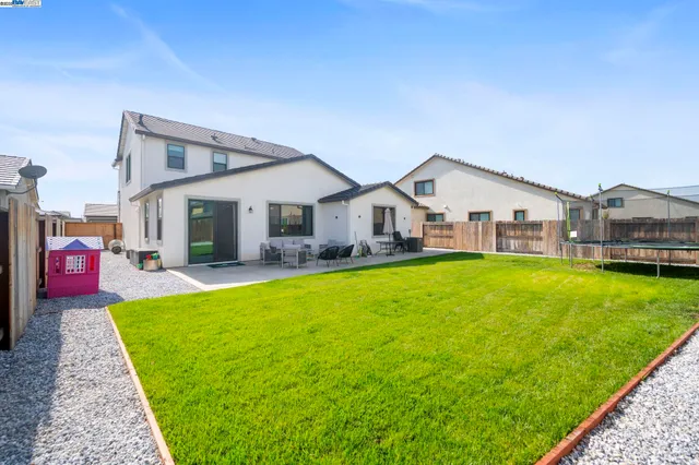 a view of a house with a yard patio and swimming pool