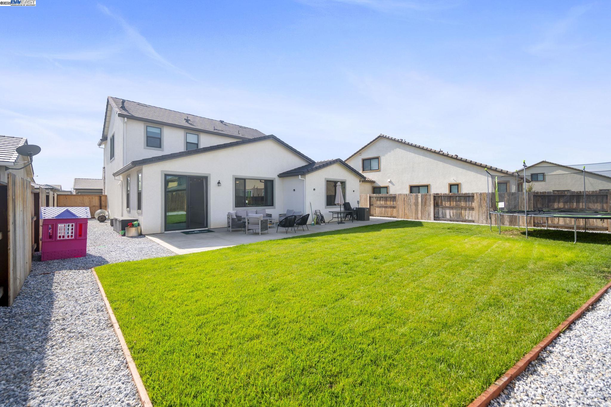 1605 Radiance Lane Modesto, CA 95356 - Photo 6 of 35 a view of a house with a yard patio and swimming pool