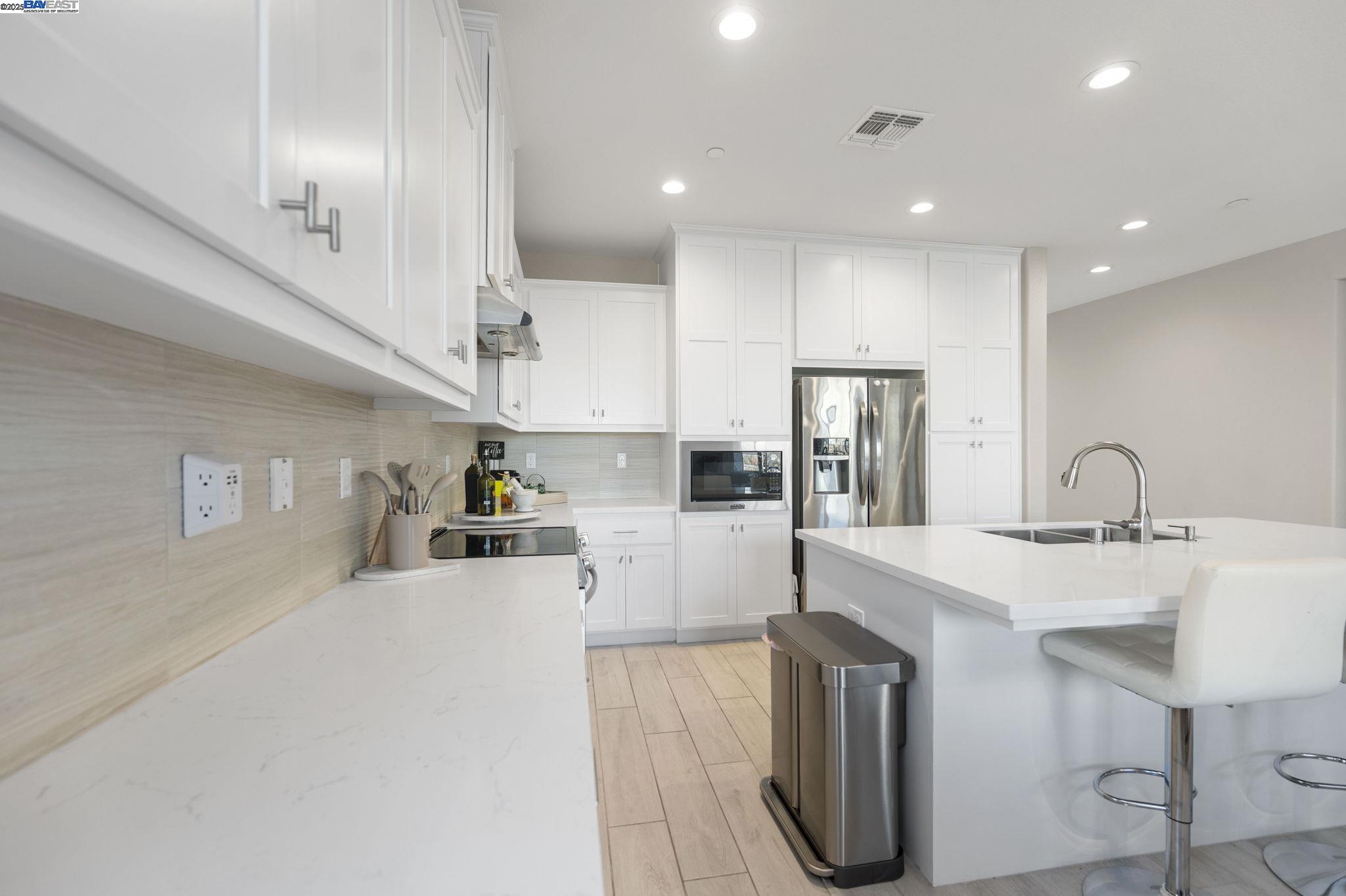 1605 Radiance Lane Modesto, CA 95356 - Photo 10 of 35 a kitchen with stainless steel appliances a sink stove and refrigerator