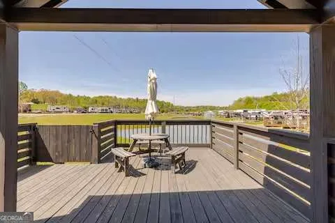 a view of a balcony with wooden floor and outdoor seating