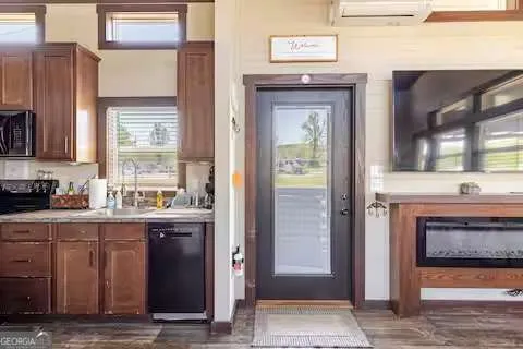 a kitchen with stainless steel appliances granite countertop a stove a sink dishwasher and cabinets with wooden floor