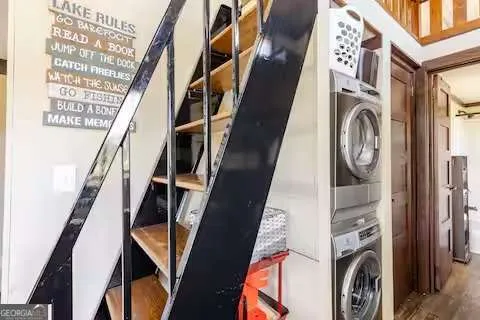 a view of a kitchen with stainless steel appliances granite countertop a stove and a sink