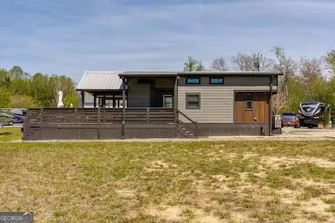 a view of a house with pool and a yard