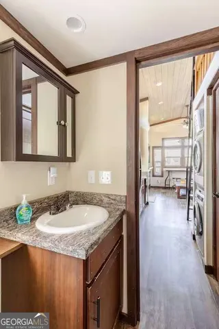 a view of a balcony with wooden floor and outdoor seating