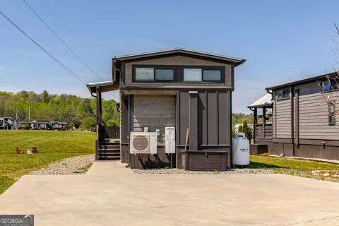a view of a ocean from a balcony with furniture