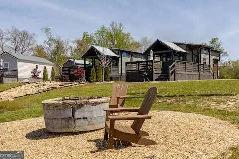 a view of a house with backyard porch and sitting area