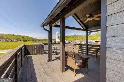 a view of a house with yard and a large tree