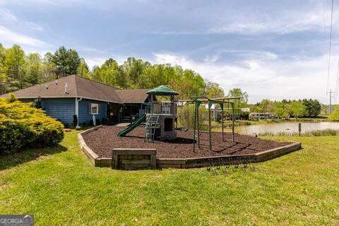 a view of a fireplace with a sink and garden in the background