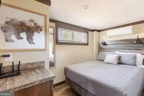 a bedroom with a granite countertop sink and lots of painting on the wall