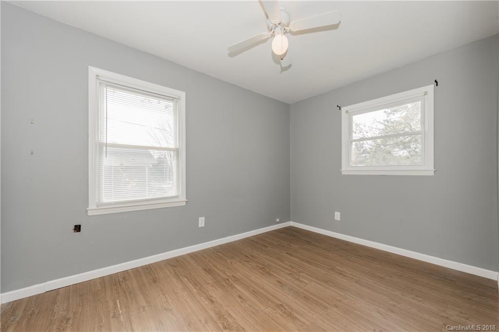 8002 Wynnview Road Indian Trail, NC 28079 - Photo 16 of 24 a view of an empty room with wooden floor and a window