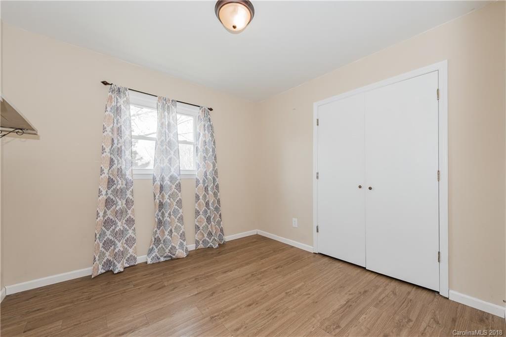 8002 Wynnview Road Indian Trail, NC 28079 - Photo 18 of 24 an empty room with wooden floor and windows
