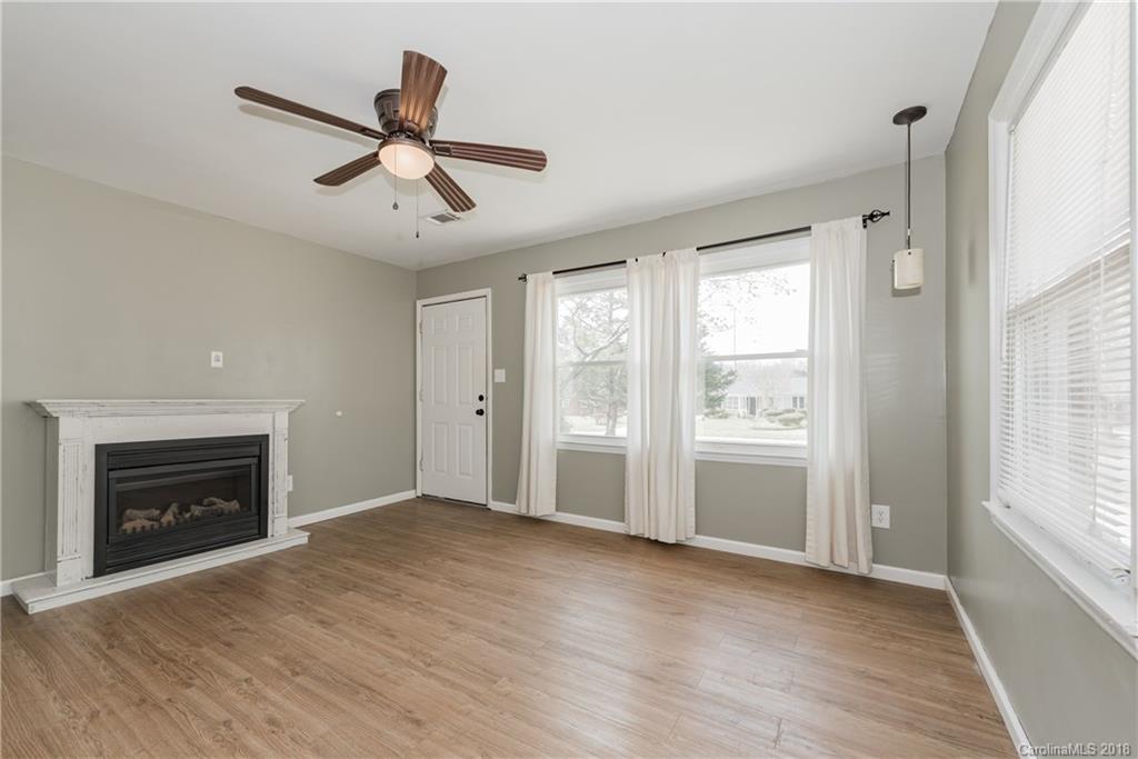 8002 Wynnview Road Indian Trail, NC 28079 - Photo 5 of 24 an empty room with windows and fireplace