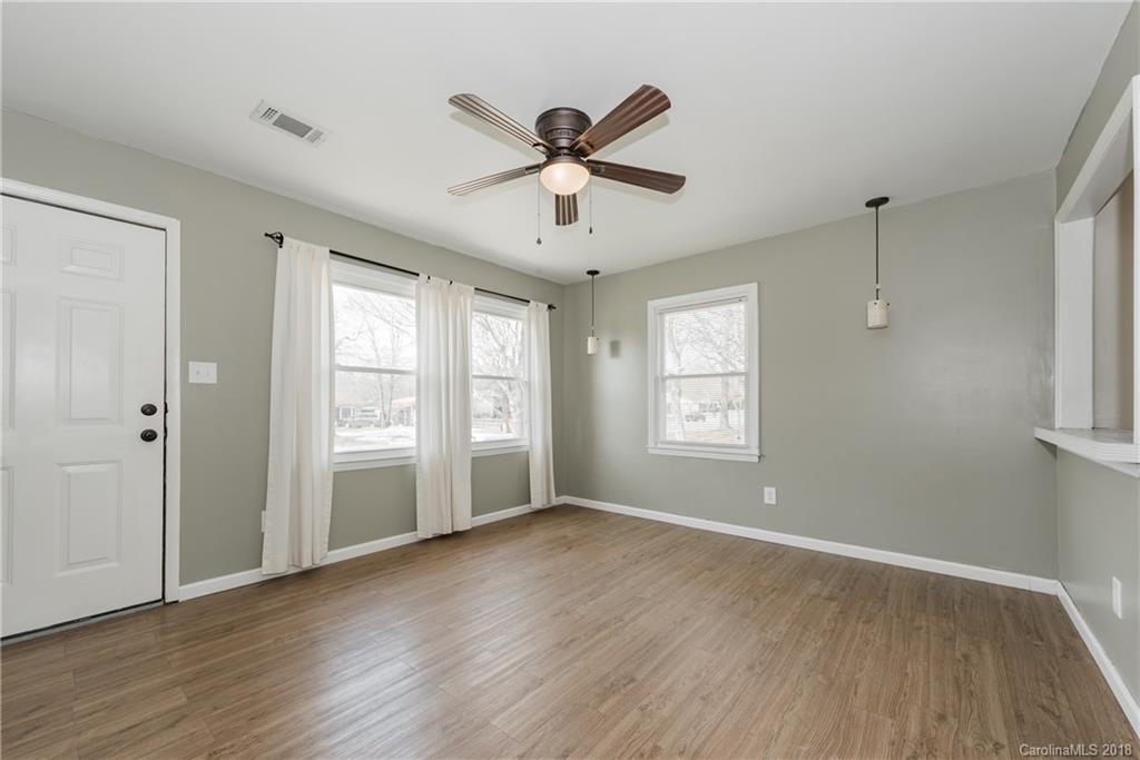 8002 Wynnview Road Indian Trail, NC 28079 - Photo 6 of 24 a view of an empty room with wooden floor and a window