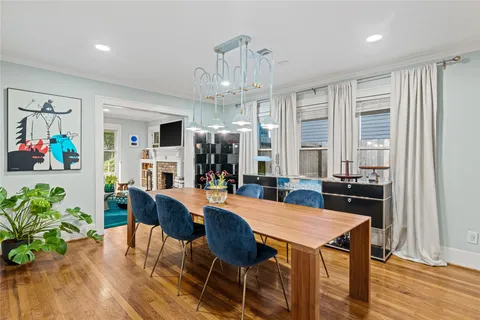 a kitchen with stainless steel appliances wooden floor dining table and chairs
